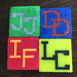 Perler Bead Tiles Four perler bead tiles with Defenders initials and Hogwarts house colours
